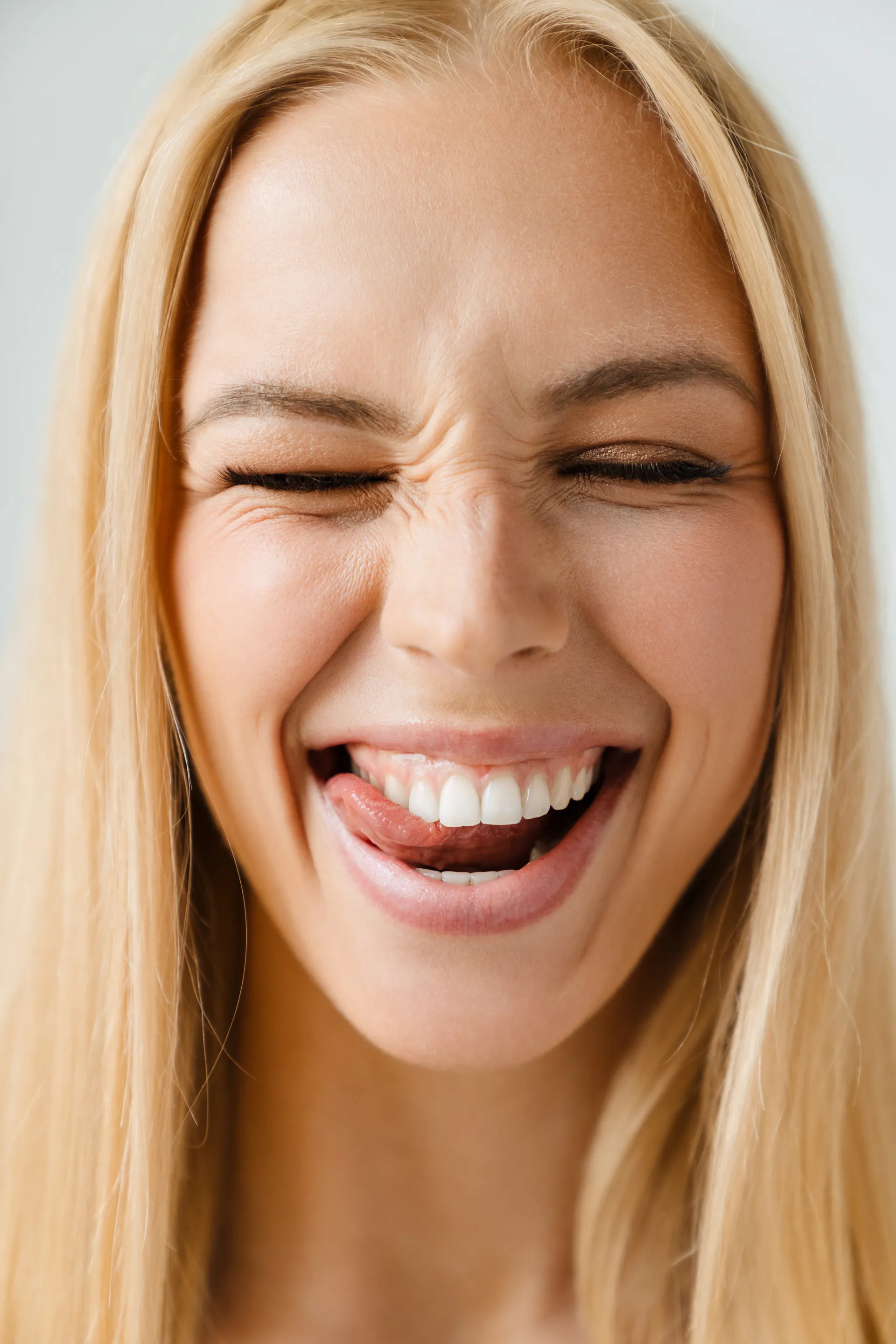 A happy woman with a bright, beautiful smile showing off her cosmetic dentistry results
